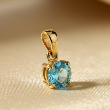 14K yellow gold round blue topaz solitaire pendant, three-quarter angle