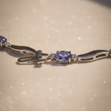 14K white gold tanzanite and diamond wave bracelet clasp end detail showing oval tanzanite station and box clasp