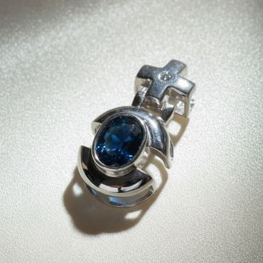 14K white gold oval blue sapphire and diamond cross bail pendant, top-down angle