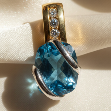 14K two-tone gold blue topaz and diamond pendant, top-down angle