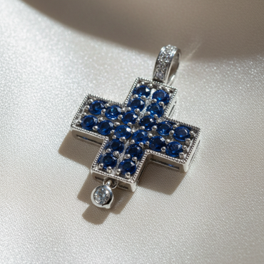 14K white gold blue sapphire and diamond cross pendant, three-quarter angle