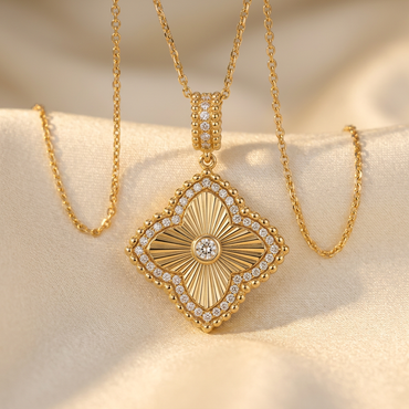 DOV 18K yellow gold diamond fluted quatrefoil pendant with chain on cream satin