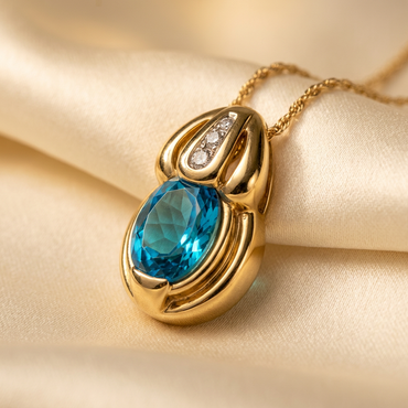 14K yellow gold blue topaz and diamond pendant, three-quarter view