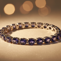 Sterling silver oval tanzanite and diamond tennis bracelet on cream satin, editorial luxury photography