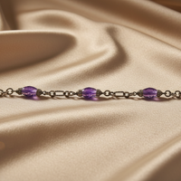 Sterling silver amethyst and diamond station chain bracelet on cream satin, editorial luxury photography