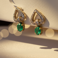 14K Two-Tone Gold Oval Emerald Drop Earrings with Diamond Heart Frame - Three-Quarter View