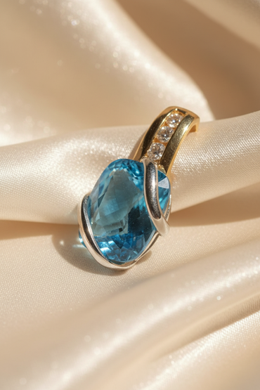 14K two-tone gold blue topaz and diamond pendant, three-quarter angle