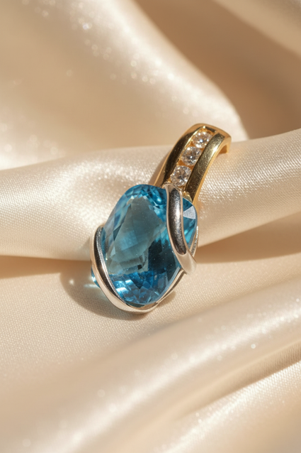 14K two-tone gold blue topaz and diamond pendant, three-quarter angle