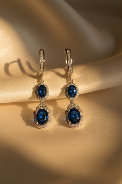Close-up of sterling silver blue sapphire and diamond halo drop earrings