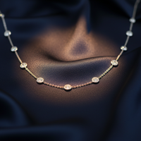 18K White Gold Diamond Bezel Station Necklace on midnight blue silk backdrop editorial marketing image