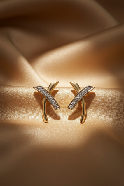14K Yellow Gold Diamond Wishbone X-Cross Earrings on champagne gold silk backdrop editorial marketing image
