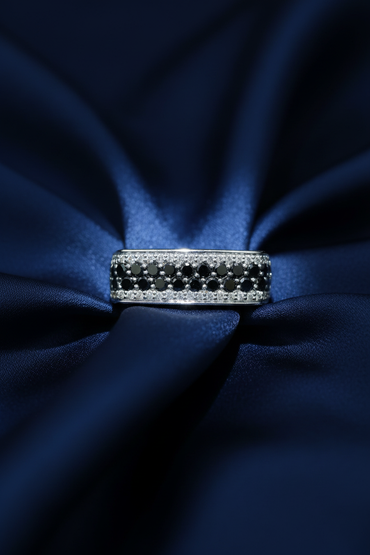 10K White Gold Men's Black and White Diamond Band Ring on midnight blue silk backdrop editorial marketing image