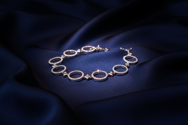 18K White Gold Diamond Open Circle Link Bracelet on navy silk backdrop editorial marketing image