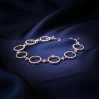18K White Gold Diamond Open Circle Link Bracelet on navy silk backdrop editorial marketing image