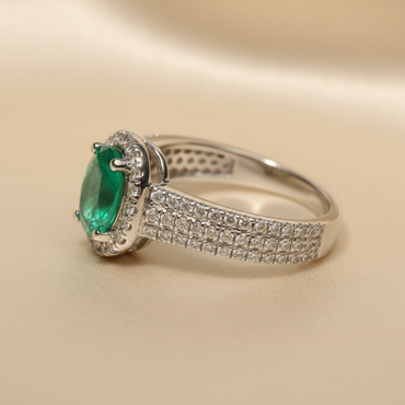 18K White Gold Oval Emerald & Diamond Halo Ring - editorial angled side