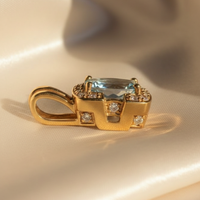 18K Yellow Gold Oval Aquamarine and Diamond Pendant - side profile, cream satin