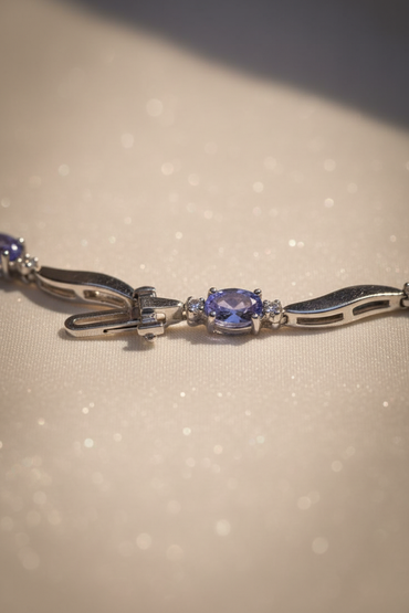 14K white gold tanzanite and diamond wave bracelet clasp end detail showing oval tanzanite station and box clasp