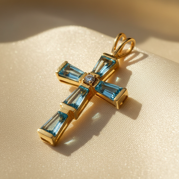 14K yellow gold cross pendant with baguette-cut blue topaz arms and round brilliant diamond center, angle 3