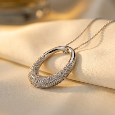 14K white gold 0.85 ctw diamond O pendant, angled view on cream satin