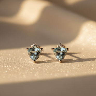 14K White Gold Trillion Aquamarine and Diamond Stud Earrings on cream satin