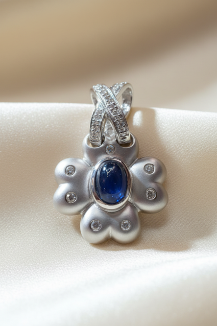14K white gold blue sapphire and diamond flower pendant, front view
