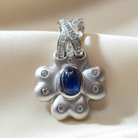 14K white gold blue sapphire and diamond flower pendant, front view