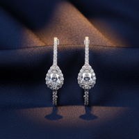 18K White Gold Pavé Diamond Full Hoop Lever-Back Earrings on midnight blue silk backdrop editorial marketing image