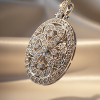 18K white gold .56ctw diamond art deco oval filigree locket, elevated three-quarter view