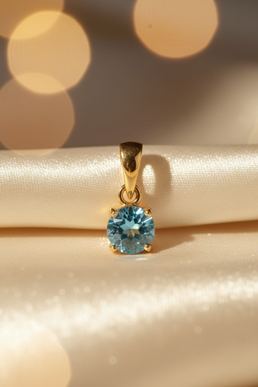 14K yellow gold round blue topaz solitaire pendant, front view