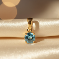 14K yellow gold round blue topaz solitaire pendant, front view