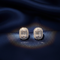 14K White Gold Diamond Cushion Baguette Cluster Halo Stud Earrings on midnight blue silk backdrop editorial marketing image