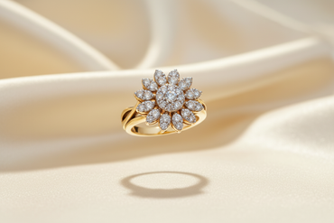 14K yellow gold diamond sunflower cluster ring floating on cream silk backdrop with warm accent lighting