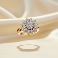 14K yellow gold diamond sunflower cluster ring floating on cream silk backdrop with warm accent lighting