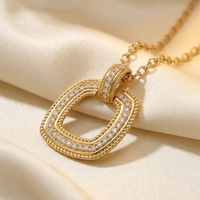 DOV 18K yellow gold diamond open cushion pendant, angled view on cream satin