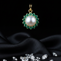 Yellow gold freshwater pearl and emerald halo pendant - front view