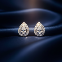 14K White Gold Pear Diamond Halo Stud Earrings on midnight blue silk backdrop editorial marketing image