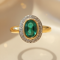 14K yellow gold oval emerald bezel-set diamond pavé halo ring, front view