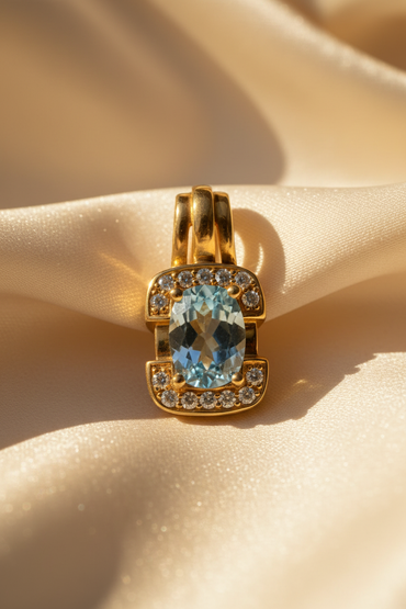 18K Yellow Gold Oval Aquamarine and Diamond Pendant - front view, 7 diamonds top and bottom, cream satin