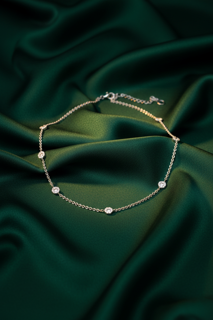 18K White Gold Diamond Daisy Station Necklace on emerald silk backdrop editorial marketing image