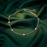 18K White Gold Diamond Daisy Station Necklace on emerald silk backdrop editorial marketing image