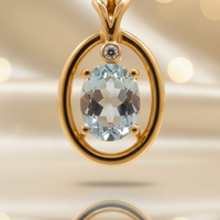 14K yellow gold aquamarine and diamond oval frame pendant, front view