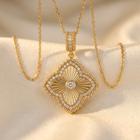 DOV 18K yellow gold diamond fluted quatrefoil pendant with chain on cream satin