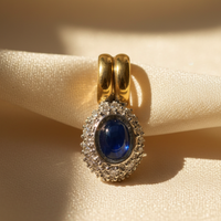 18K Two-Tone Gold Blue Sapphire Cabochon & Diamond Halo Pendant - Marketing Image