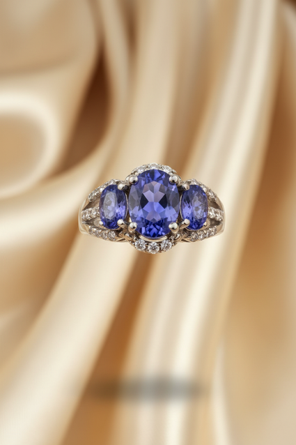 14K white gold three-stone oval tanzanite ring with diamond accents, front view