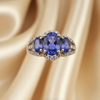 14K white gold three-stone oval tanzanite ring with diamond accents, front view