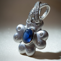 14K white gold blue sapphire and diamond flower pendant, three-quarter angle