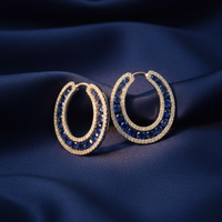 14K White Gold Blue Sapphire and Diamond Open Hoop Earrings on midnight blue silk backdrop editorial marketing image