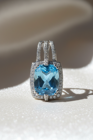 14K white gold cushion blue topaz and diamond halo pendant, front view