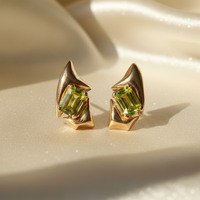 14K yellow gold sculptural peridot earrings - editorial marketing image