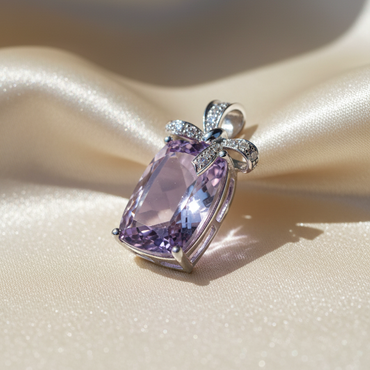 14K White Gold Cushion Amethyst and Diamond Bow Pendant - angled view on cream satin